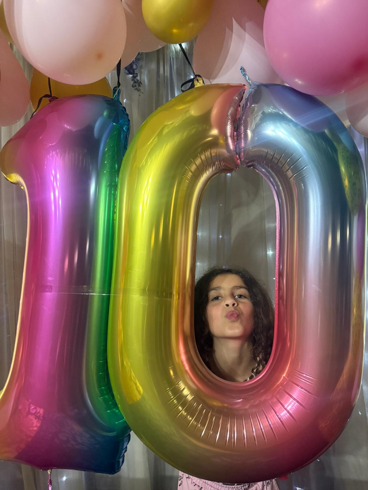 Birthday girl with number balloons